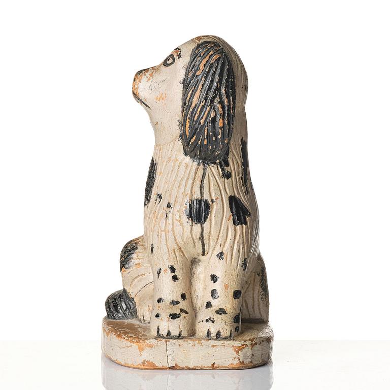 A Swedish wooden folk-art sculpture depicting a 'Staffordshire dog' ceramic figurine, 19th century.