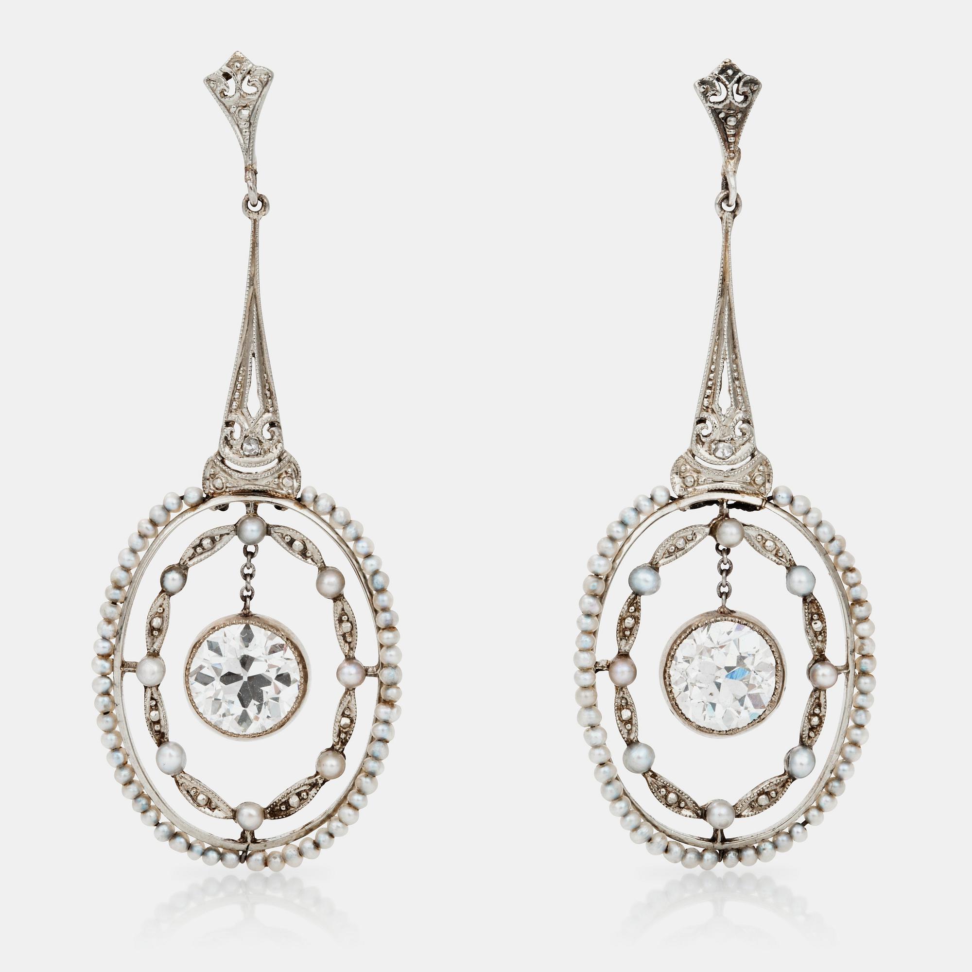 A pair of seed-pearl and diamond earrings. Total diamond weight circa 2.50 cts.