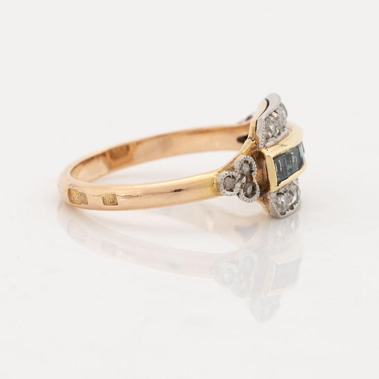 A 14K gold and platinum ring set with green stones and rose-cut diamonds.