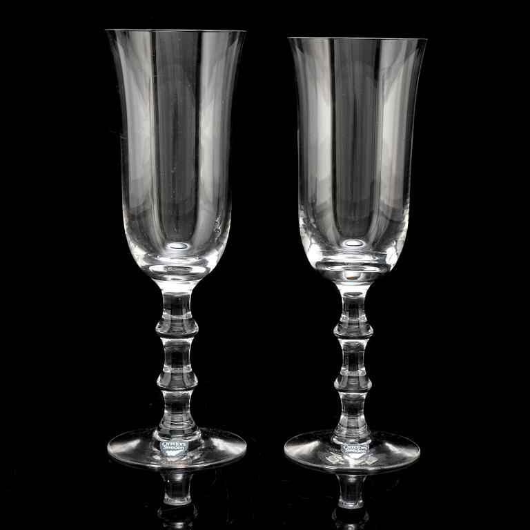 A set of twelve champagne glasses by Simon Gate.