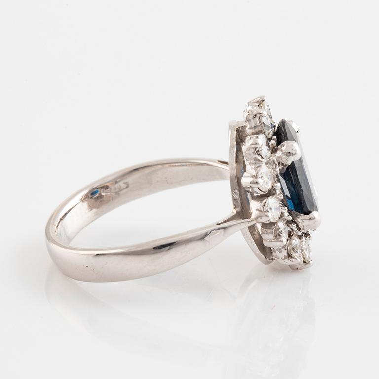 Dark sapphire and brilliant cut diamond ring.