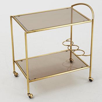 A 1970's glass and brass drinks trolley.