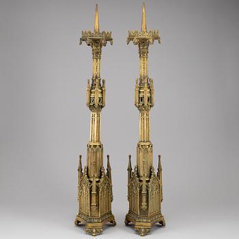 A pair of Pugin style gothic revival candlesticks, mid 19th century.