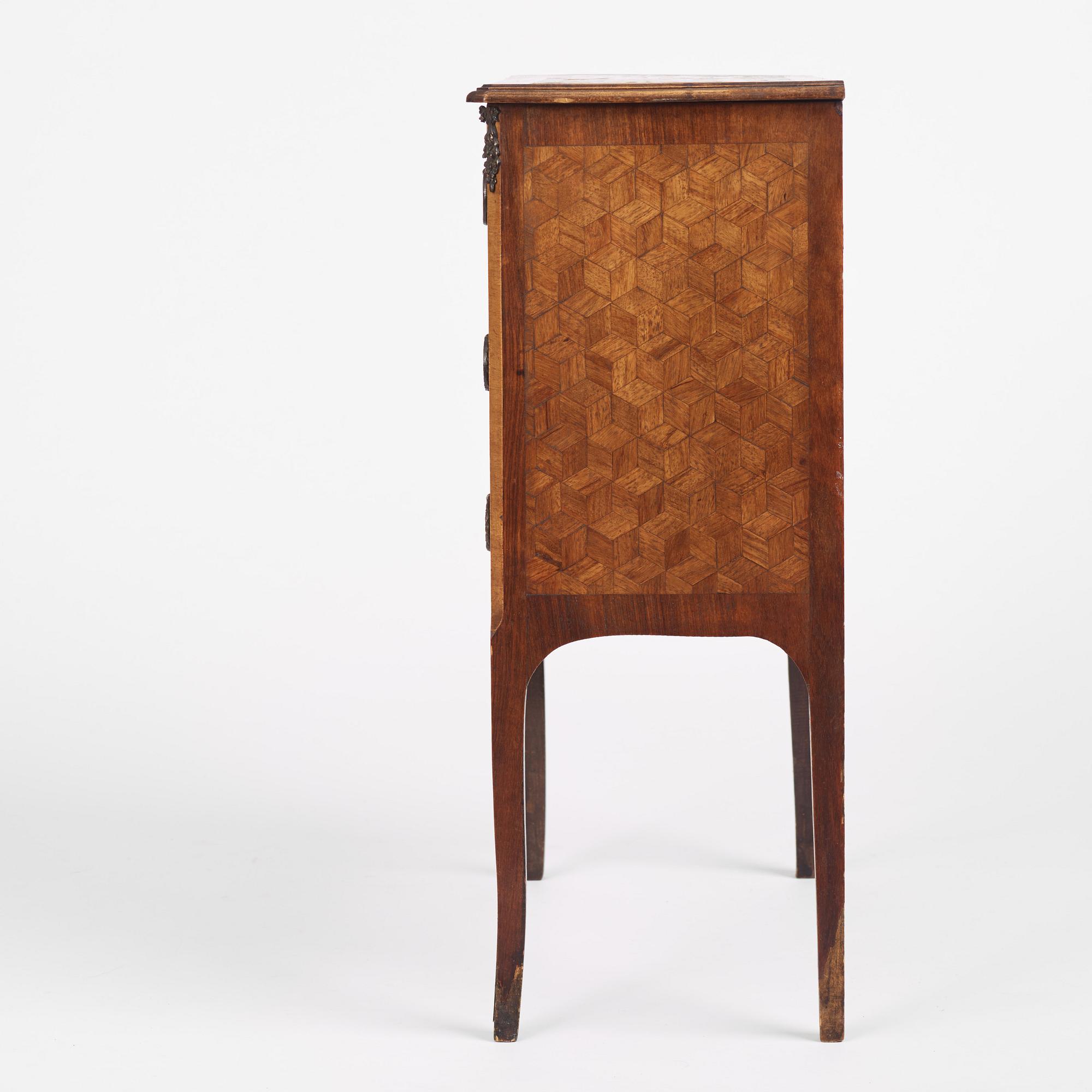 A Louis XVI-style parquetry commode, circa 1900.