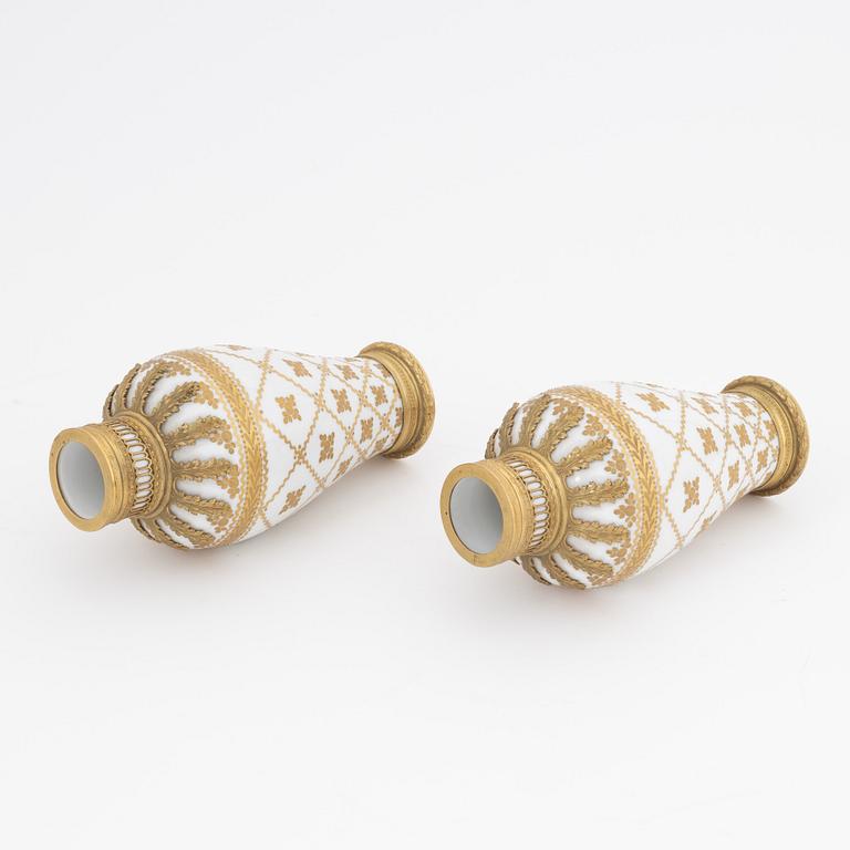 A pair of brass-mounted porcelain  vases, Sèvres mock marks, around 1900.