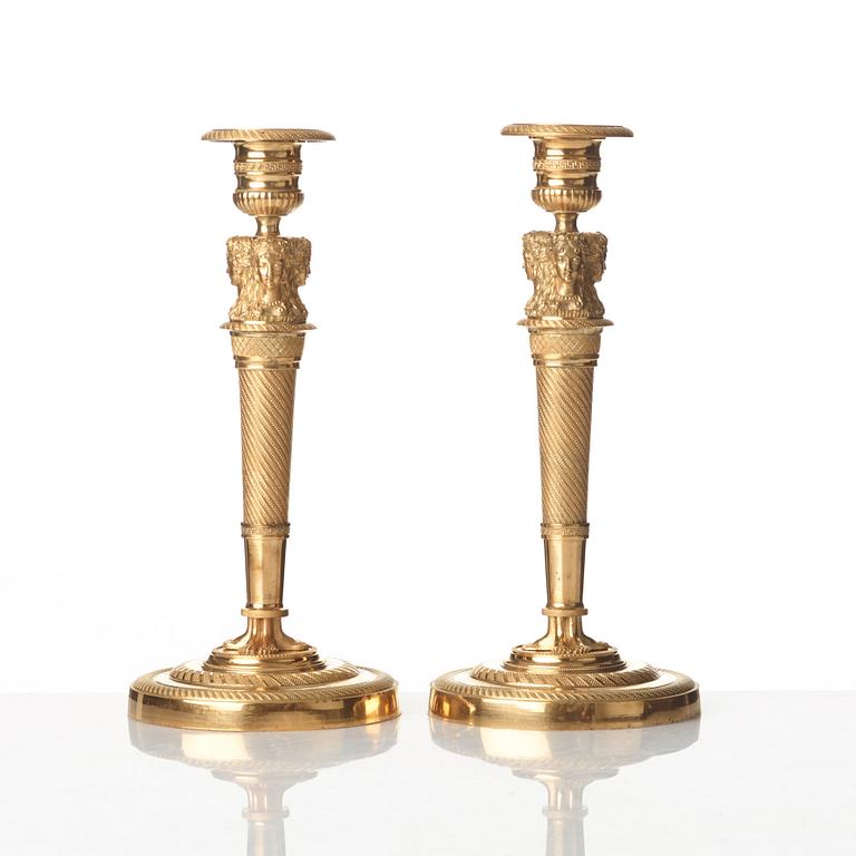 A pair of French Empire early 19th century gilt bronze candlesticks.