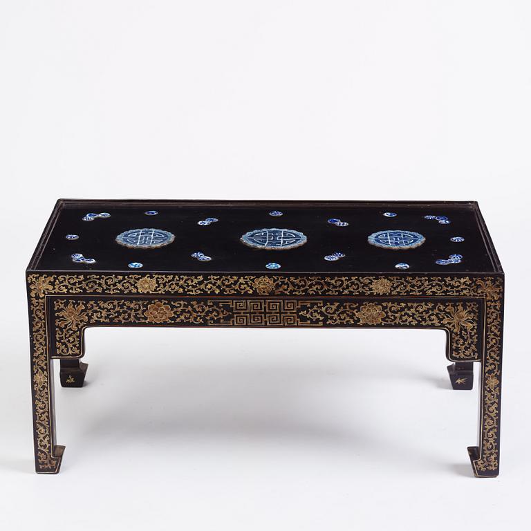 A Chinese black lacquered table with porcelain placques, presumably first half of the 20th century.