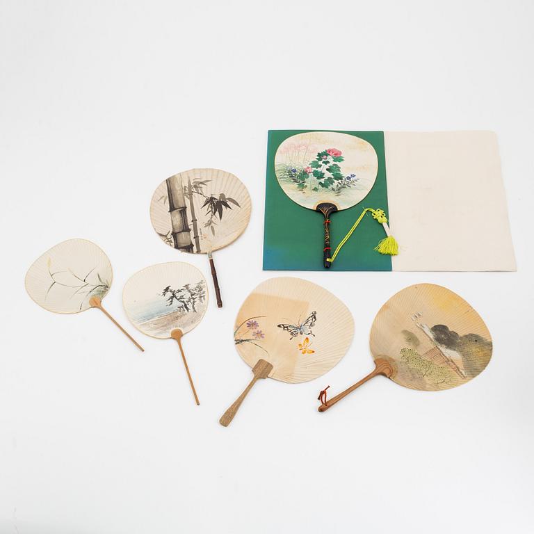 A set of six fans and two umbrellas and a wig/pony tail. Japan, early 20th Century.