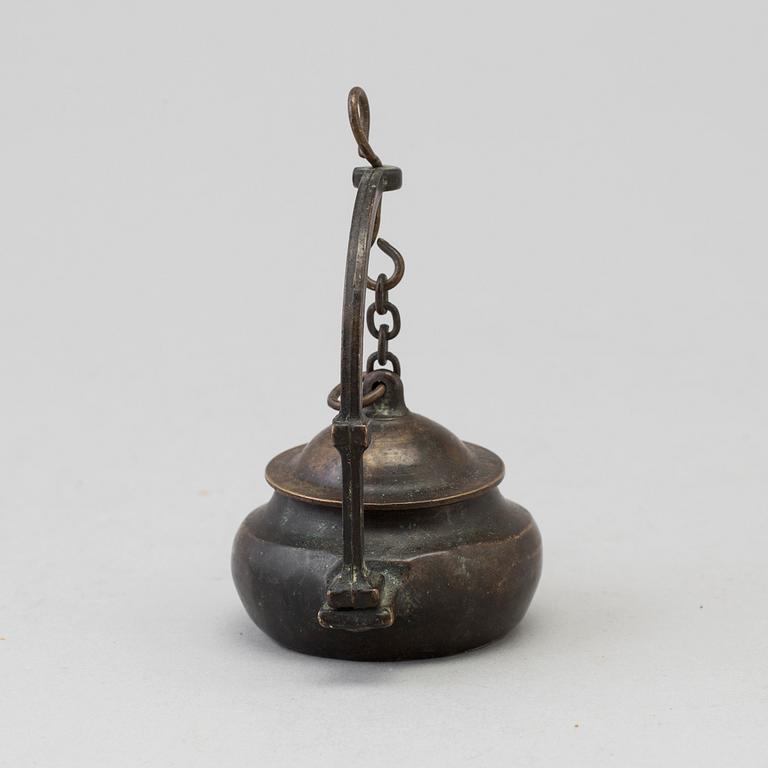 An 18th century bronze oil lamp.