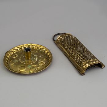 A BRASS CANDLESTICK and a GRATER, 18th century.