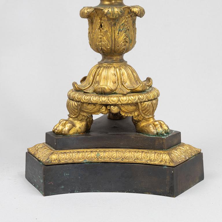 A pair of French Empire-style patinated and gilt bronze five-light candelabra, later part 19th century.