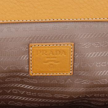 PRADA, a beige canvas clutch bag.