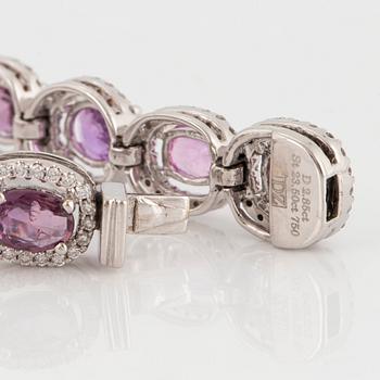 An 18K white gold bracelet set with faceted pink sapphires and round brilliant-cut diamonds.