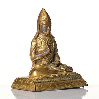 A gilt bronze figure of a Lama, Tibeto-Chinese, 18th/19th century.