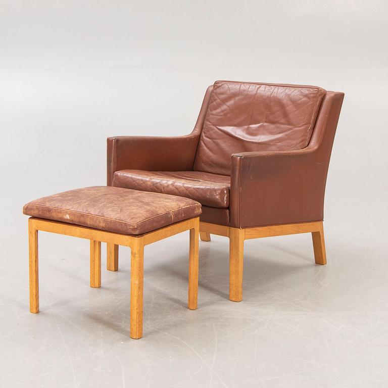 A Kai Lyngfeldt Larsen leather armchair and footstool for Söborg Möbler, Denmark, last part of the 20th century.