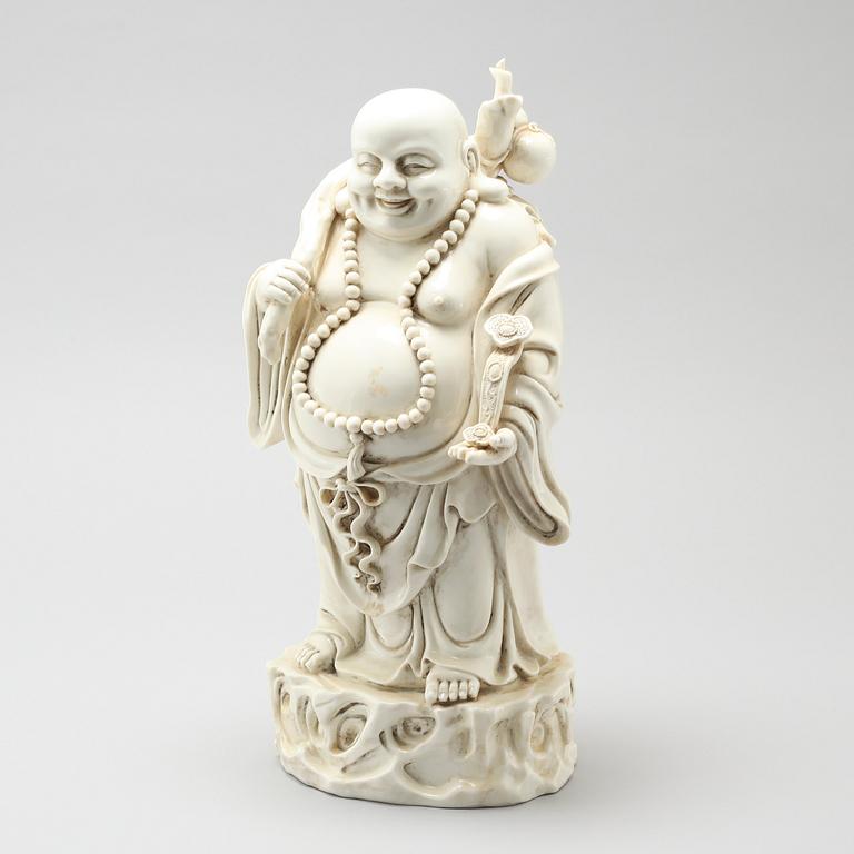 A blanc de Chine porcelian figurine of buddai, 20th Century.