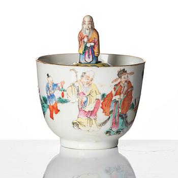 A famille rose 'trick cup' with a little figure, Qing dynasty, 19th Century.