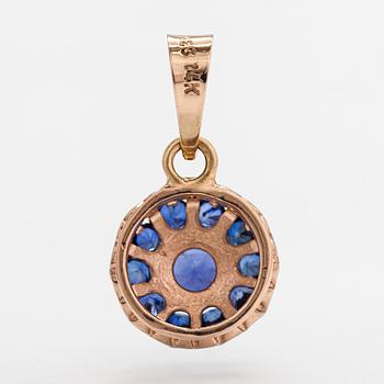 A 14K gold pendant with sapphires.