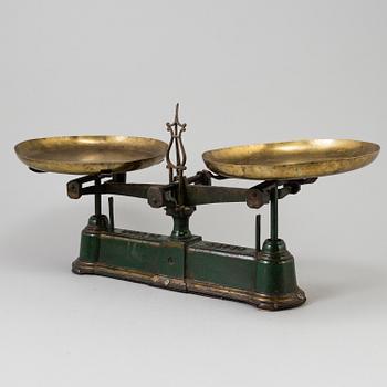 A 20th century cast iron balance with brass and iron weights, partly Skultuna, Sweden.
