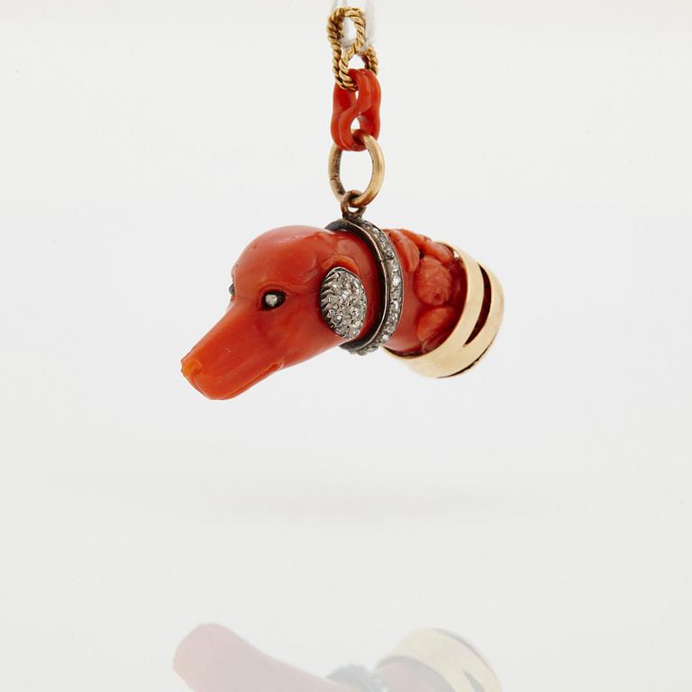 A 14 K gold and silver pendant with carved coral set with rose-cut diamonds.