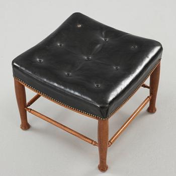A Josef Frank mahogany and black leather stool, Svenskt Tenn, model 902.