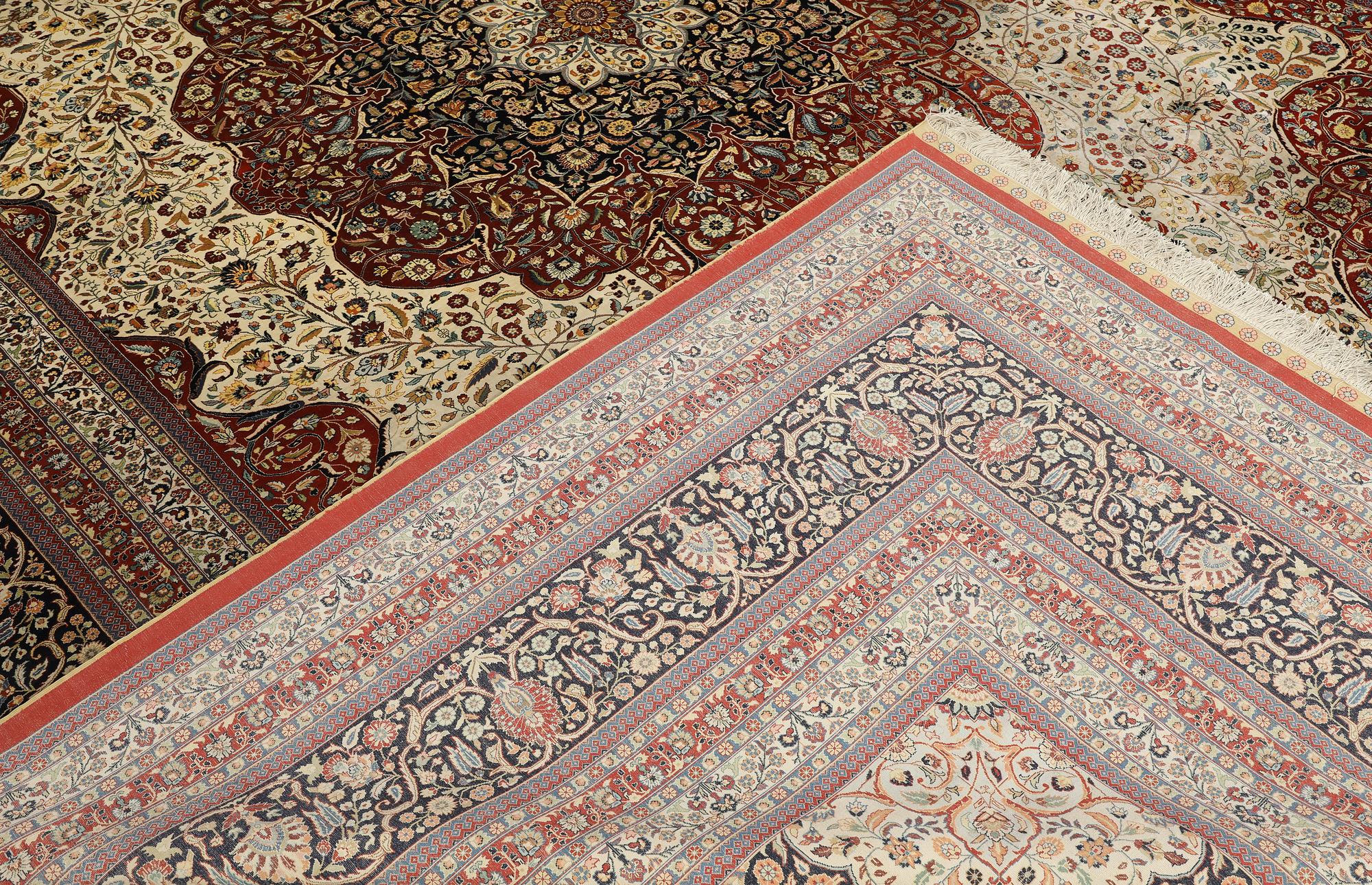 An Oriental silk carpet, c. 436 x 306 cm.