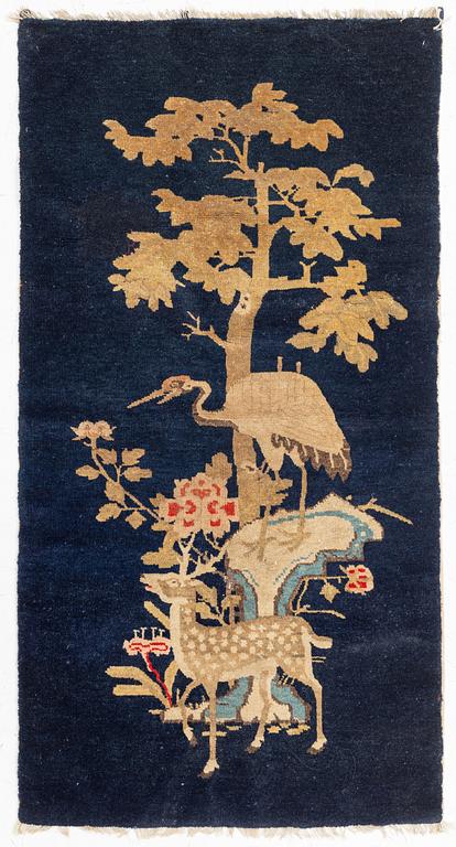 A Rug, a semi-antique Baotou figural, China, ca 127-128 x 67,5 cm.