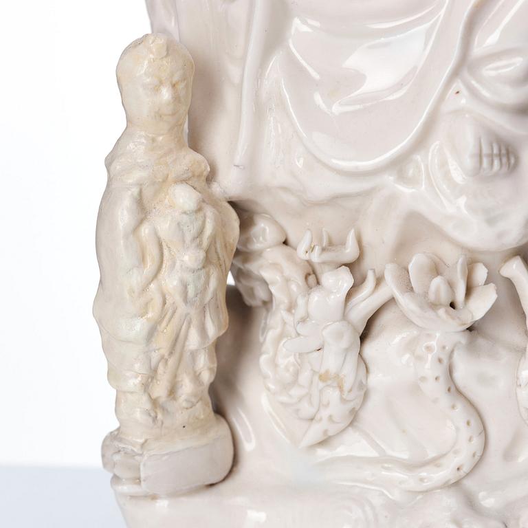 A Chinese blanc de chine Guanyin with attendants, Dehua, late Ming dynasty/early Qing dynasty.