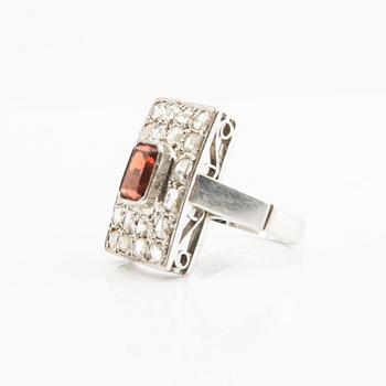 Ring, 18K white gold with a red stone (possibly garnet) and diamonds.