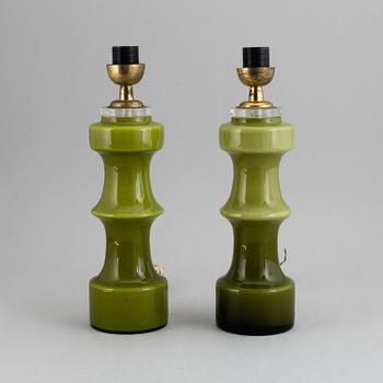 A pair of pea green glass 20th century table lamps.