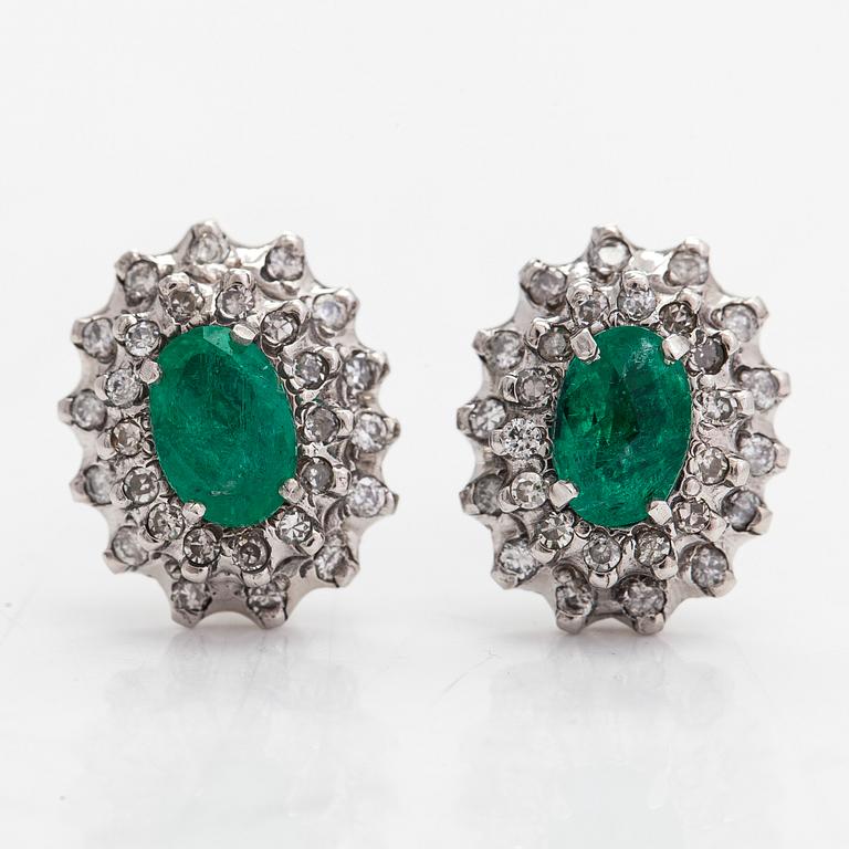 A pair of ca. 13K white gold earrings with emeralds and diamonds totaling approx. 0.80 ct.