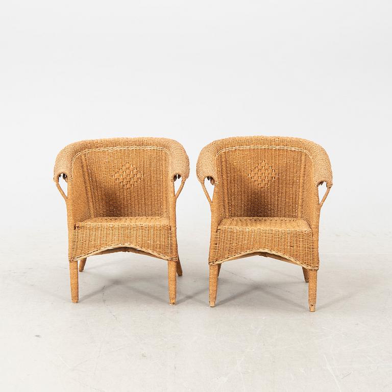 A pair of early 1900s wicker chairs.