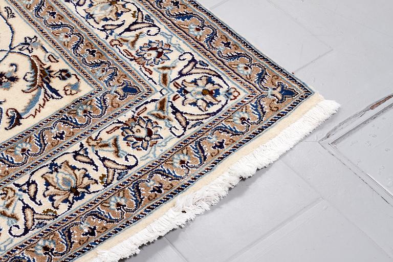 A Nain rug, part silk, 296 x187 cm.