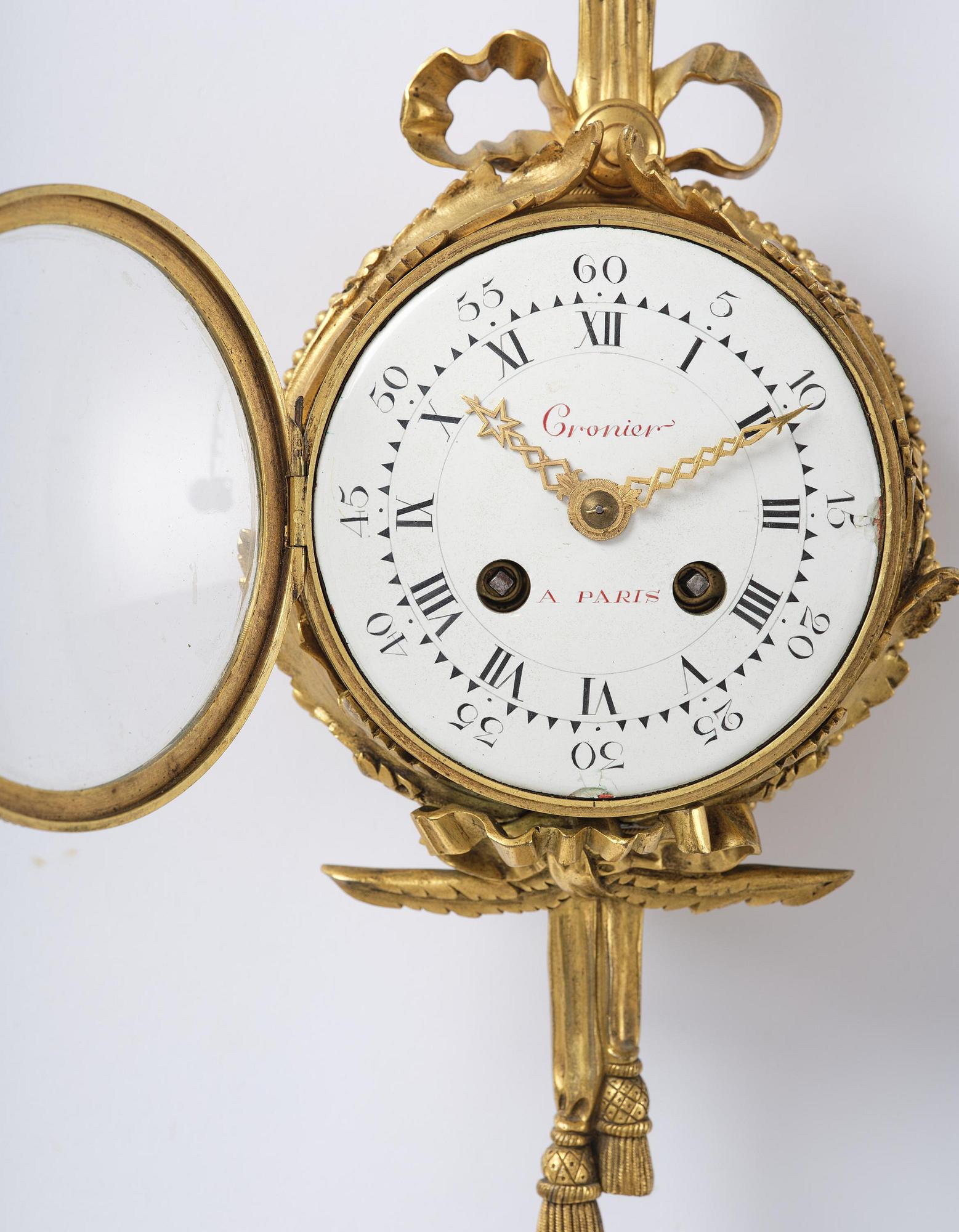A French Louis XVI-style gilt-bronze cartel clock, 19th century.