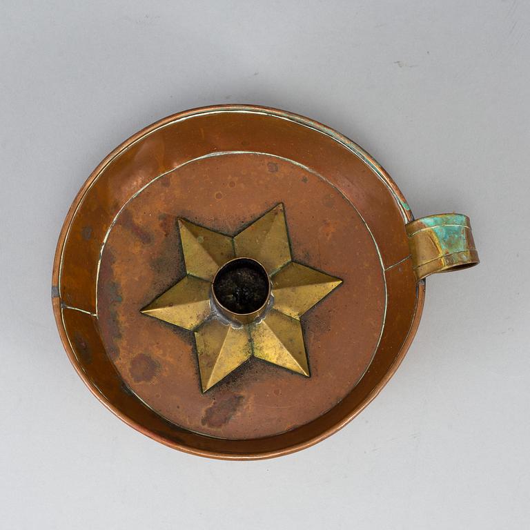 A 19th century copper and brass night light holder.