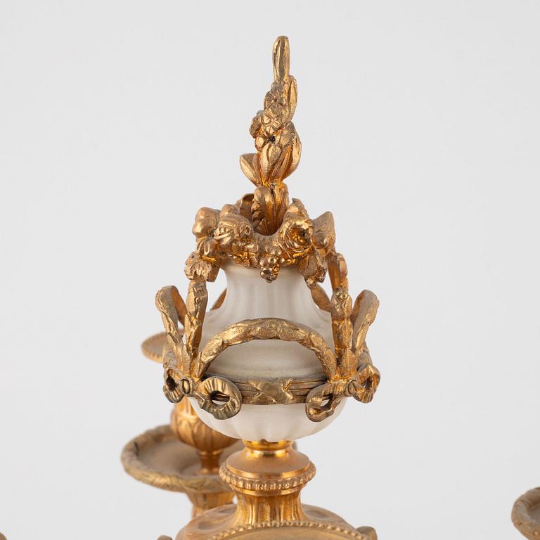 A pair of Louis XVI-style marble and gilt-bronze four-light candelabra, late 19th century.