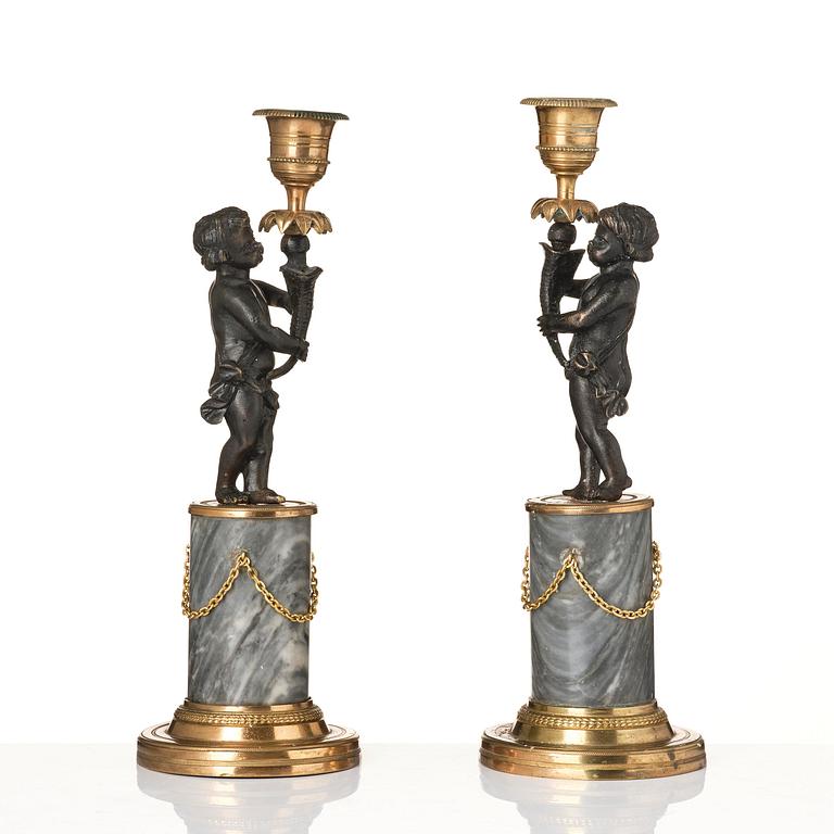 A pair of French Louis XVI ormolu and marble candlesticks, late 18th century.