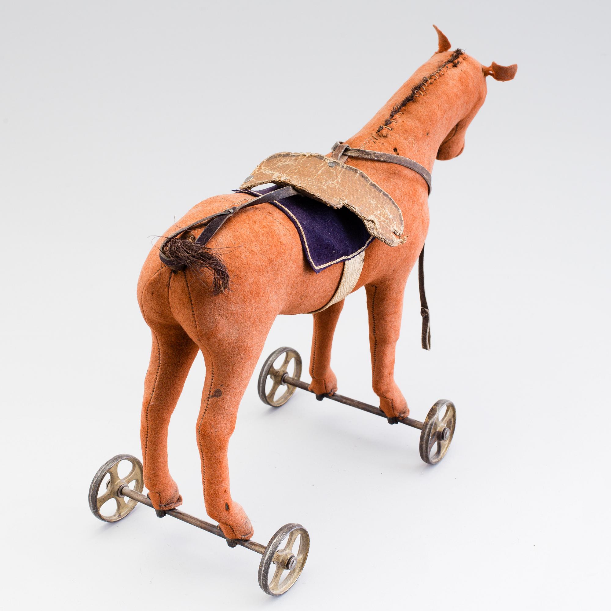 A horse on wheels probably by Steiff 1910. Bukowskis