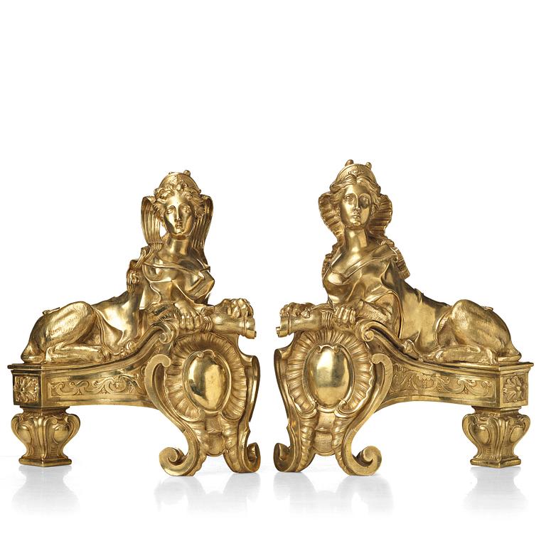 A pair of Louis XV fire dogs, France, mid 18th century, the design of the sphinxes attributed Nicolas Coustou 1658-1733.