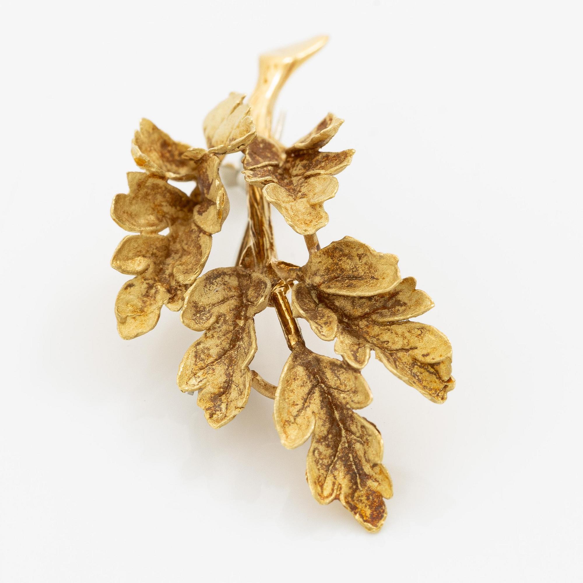 Brosch i form av ett löv 18K guld.