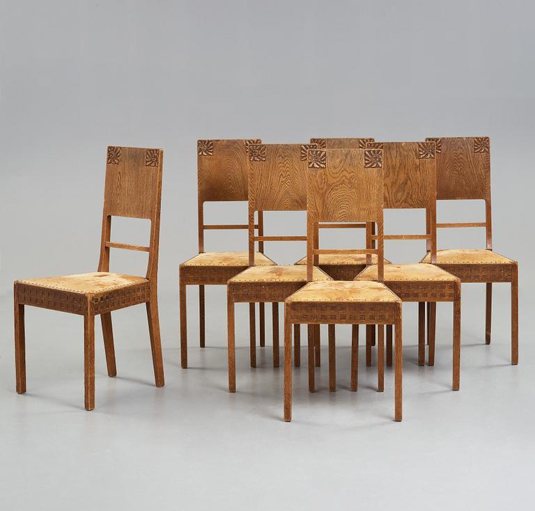 A Art Nouveau oak set with dining table, seven chairs and a side table, Finland, early 1900's.