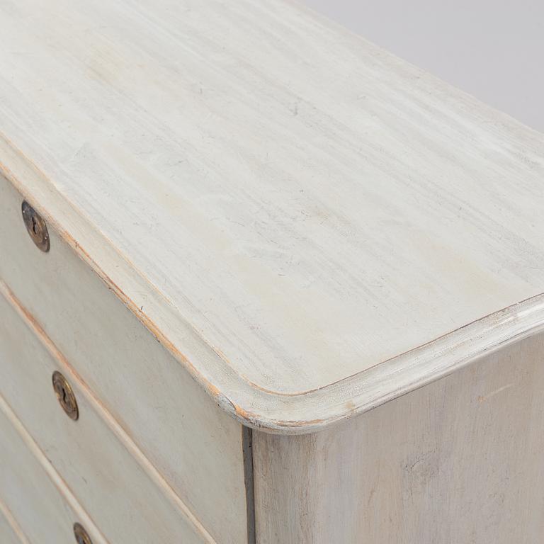 A painted chest of drawers from around the year 1900.