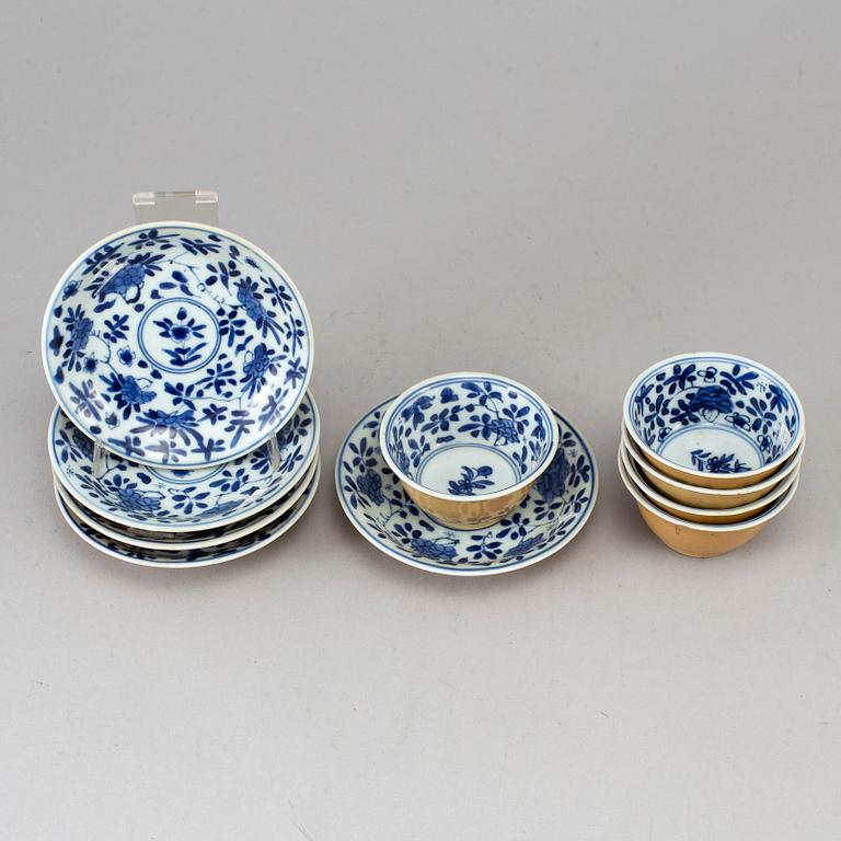 Five blue and white and cafe au lait glazed cups with dishes, Qing dynasty, Qianlong (1736-95).