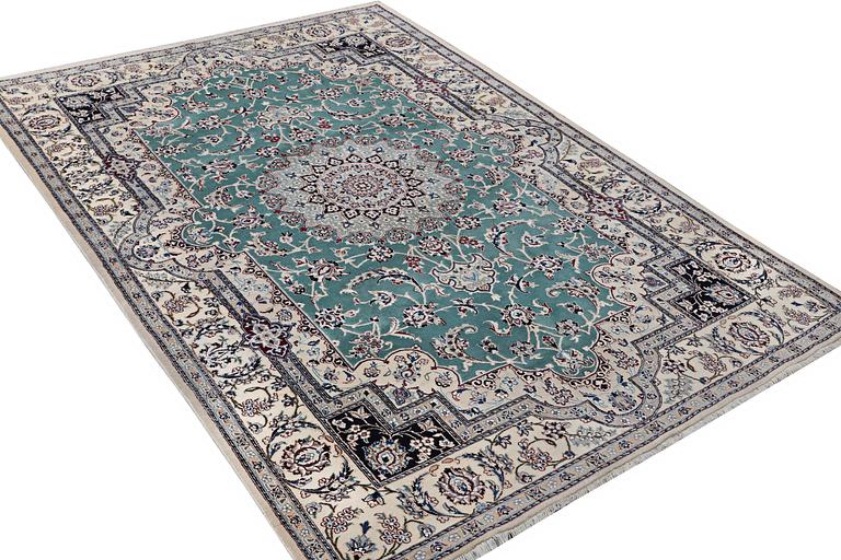 A Nain carpet, part silk, 9 laa, c. 300 x 201 cm.