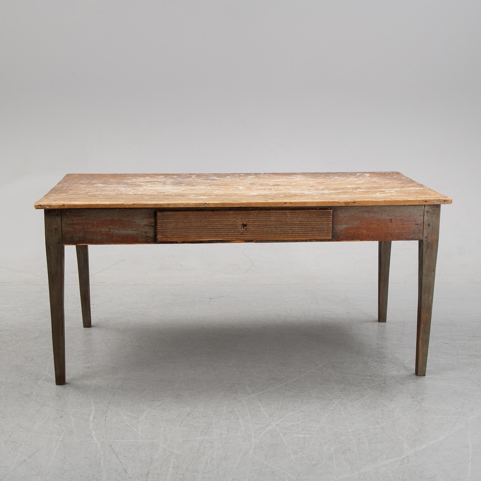 A 19th Century table with drawers.