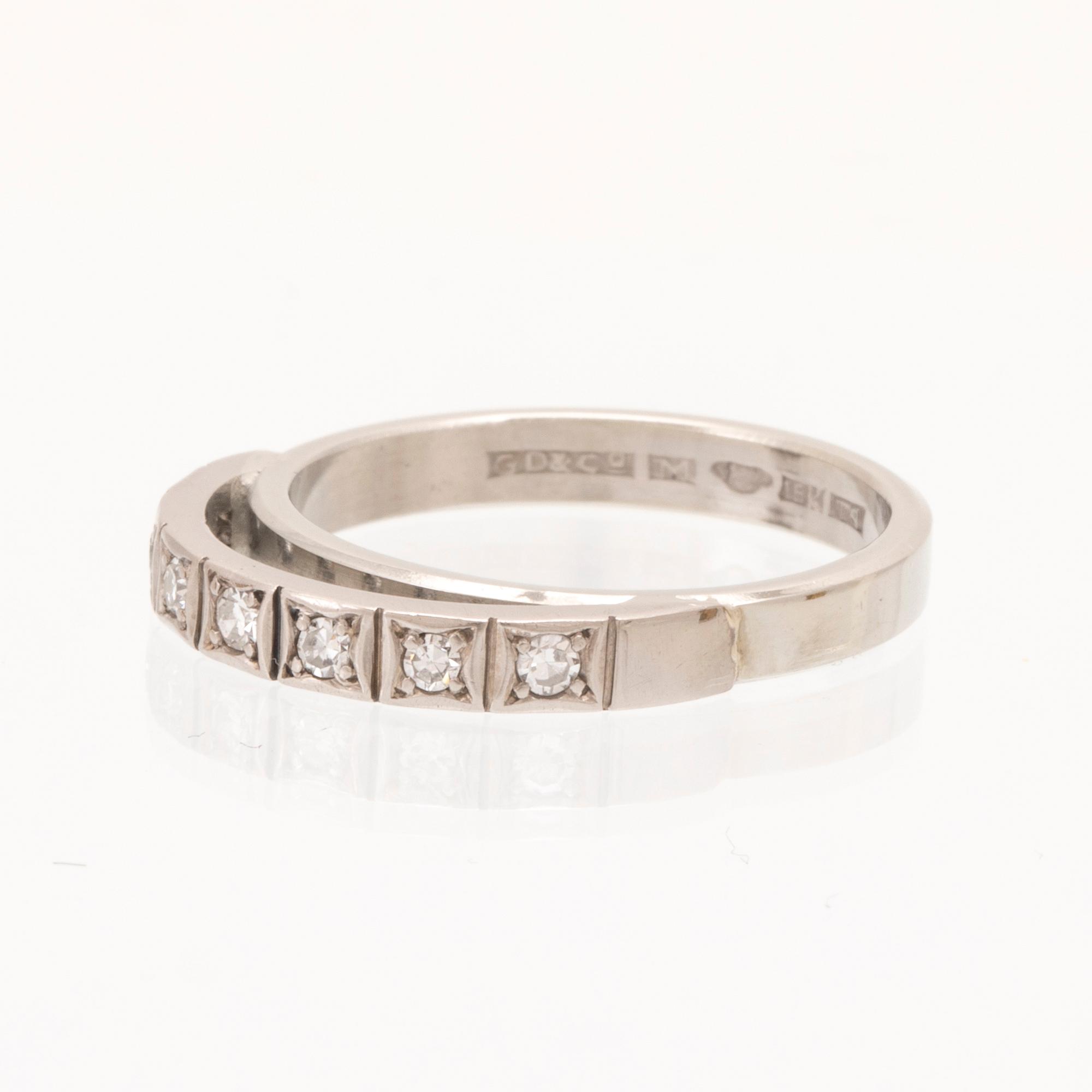 An 18K white gold ring set with round single cut dimamonds.