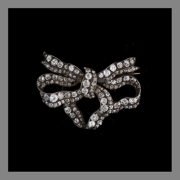 A BROOCH, gold and silver, old cut diamonds. Weight c. 17.8 g.