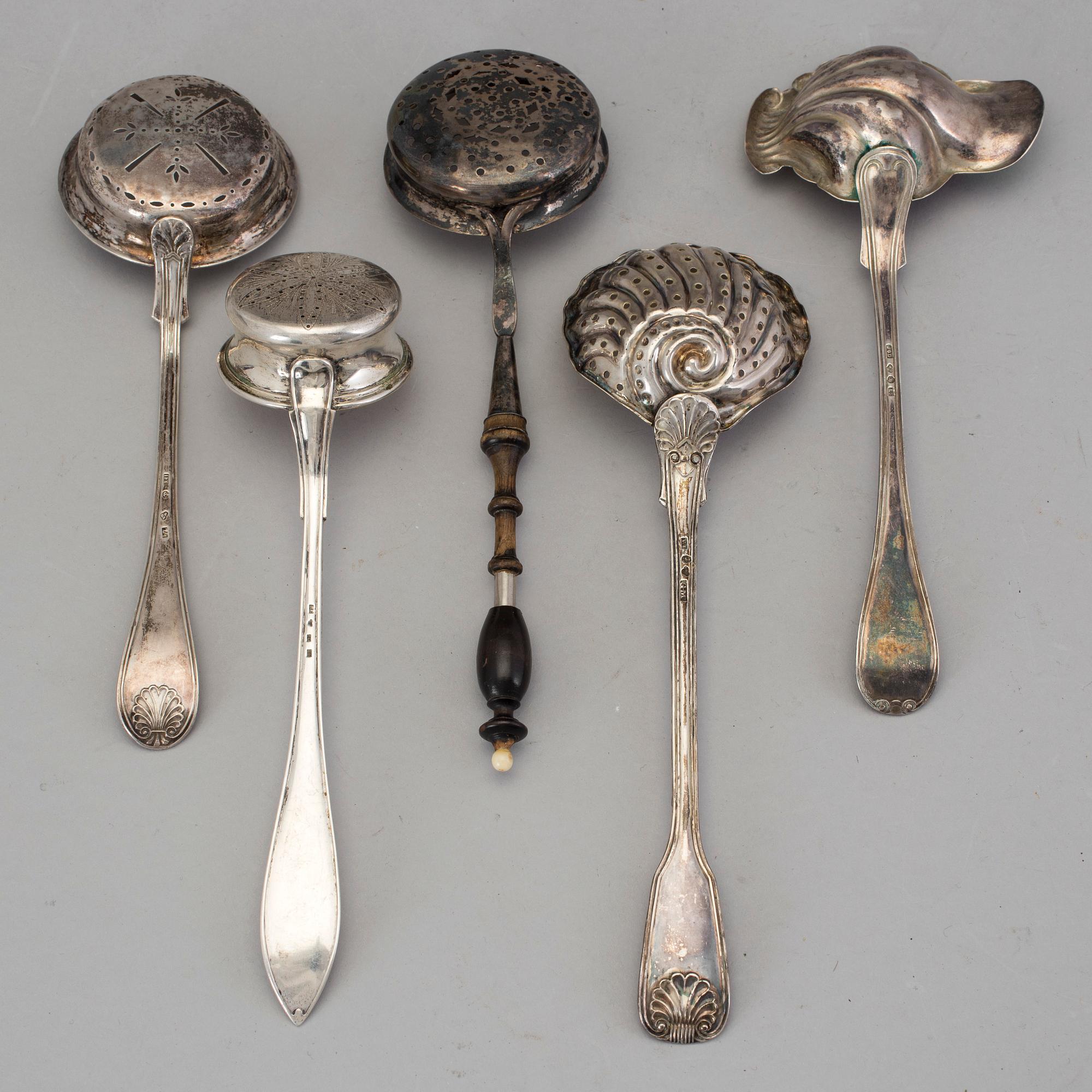 Four Swedish 19th-/20th century parcel-gilt caster-spoons and a sauce-spoon.
