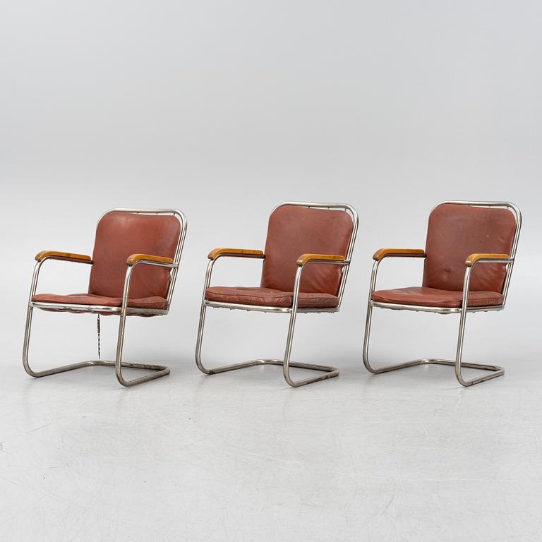 Three tubular steel armchairs, mid 20th Century.