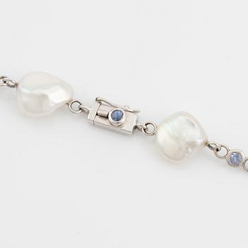 A Seaman Schepps 18K gold and cultured fresh water pearl necklace set with sapphires.